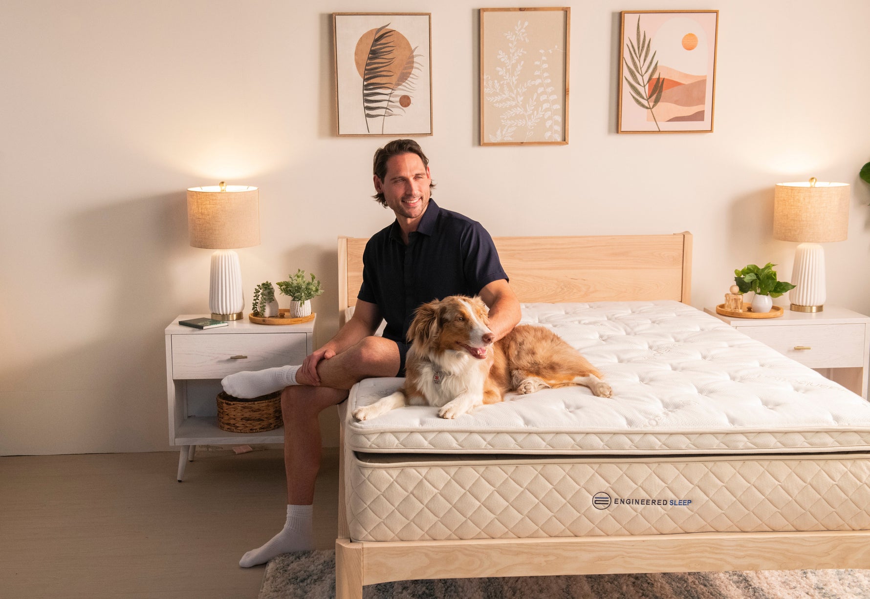 A man and dog sitting on the Duo Mattress by Engineered Sleep