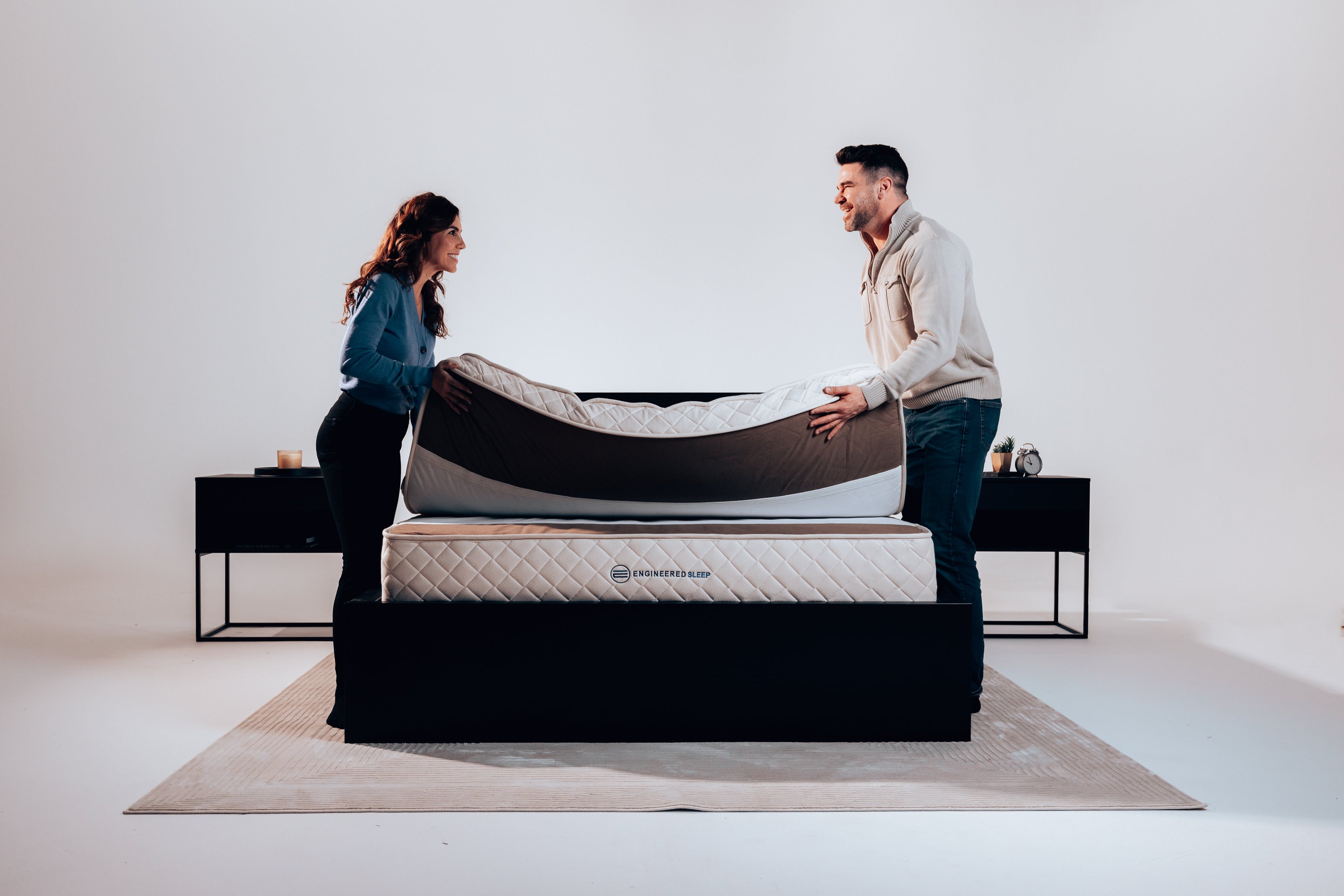 a couple adjusting the Duo Mattress Comfort Layer, front