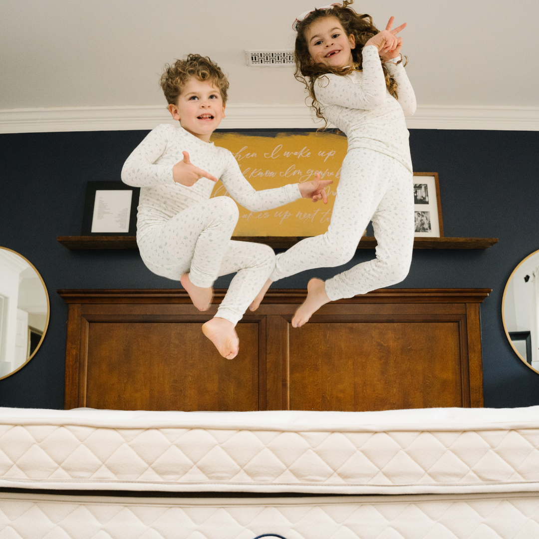 kids in pajamas jumping on an engineered sleep mattress