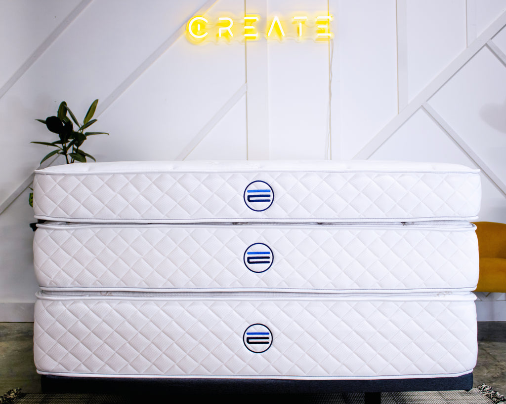 three mattresses stacked with the Engineered Sleep logo