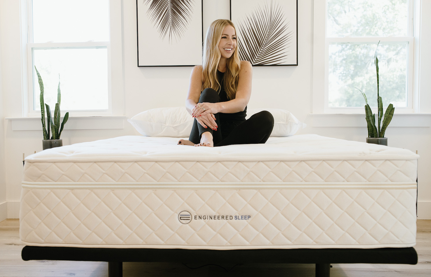 the DUO Mattress from the foot of the bed with a woman enjoying the comfort of this premium hybid latex or hybrid memory foam mattress.