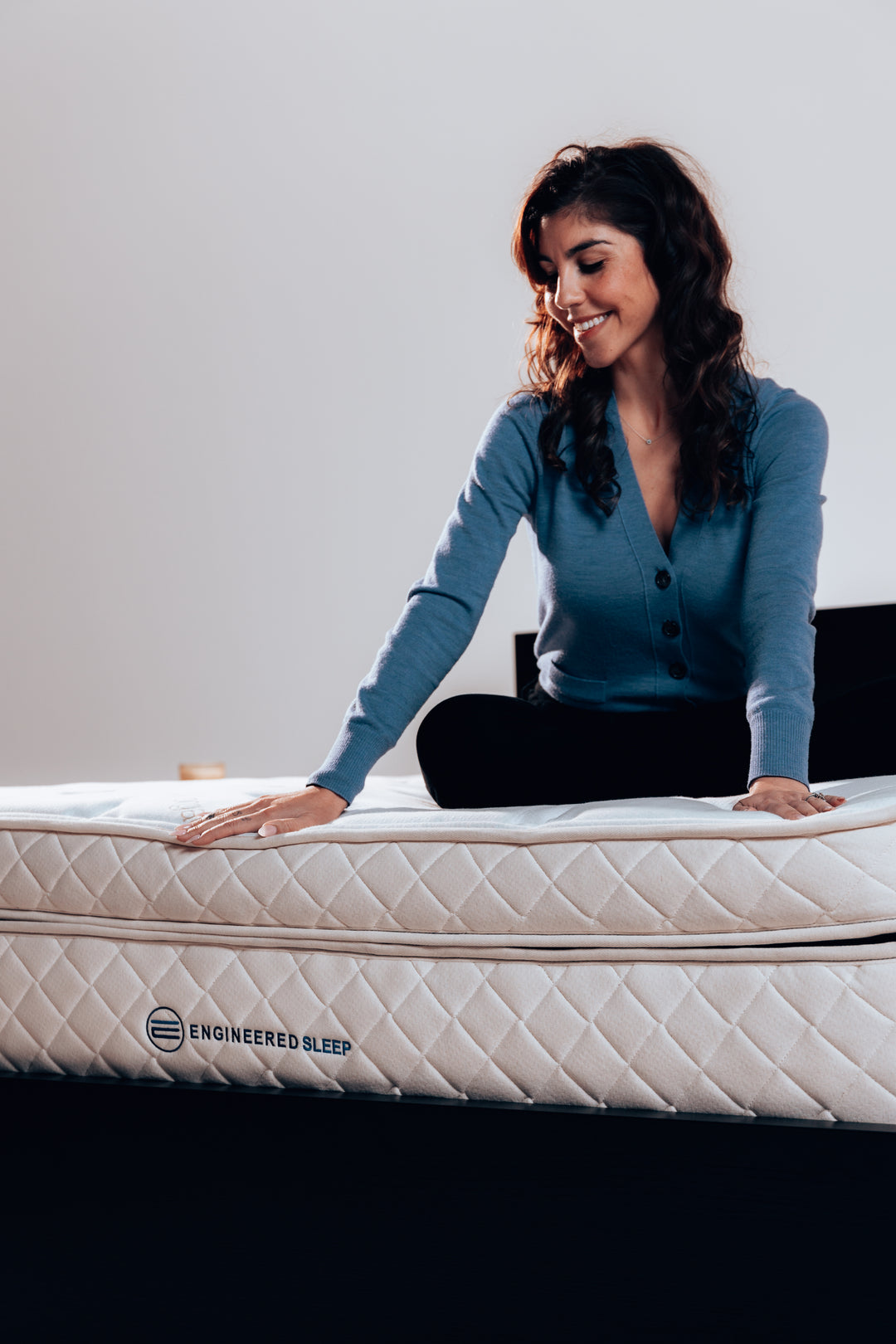 a woman enjoying our DUO Latex Plus mattress. Showcasing the soft comfort and sturdy support.