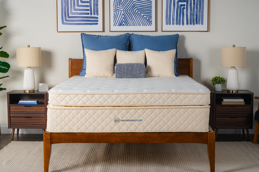 Cream-colored Duo Memory Mattress with two distinct layers on a wooden bed frame, flanked by nightstands and lamps.
